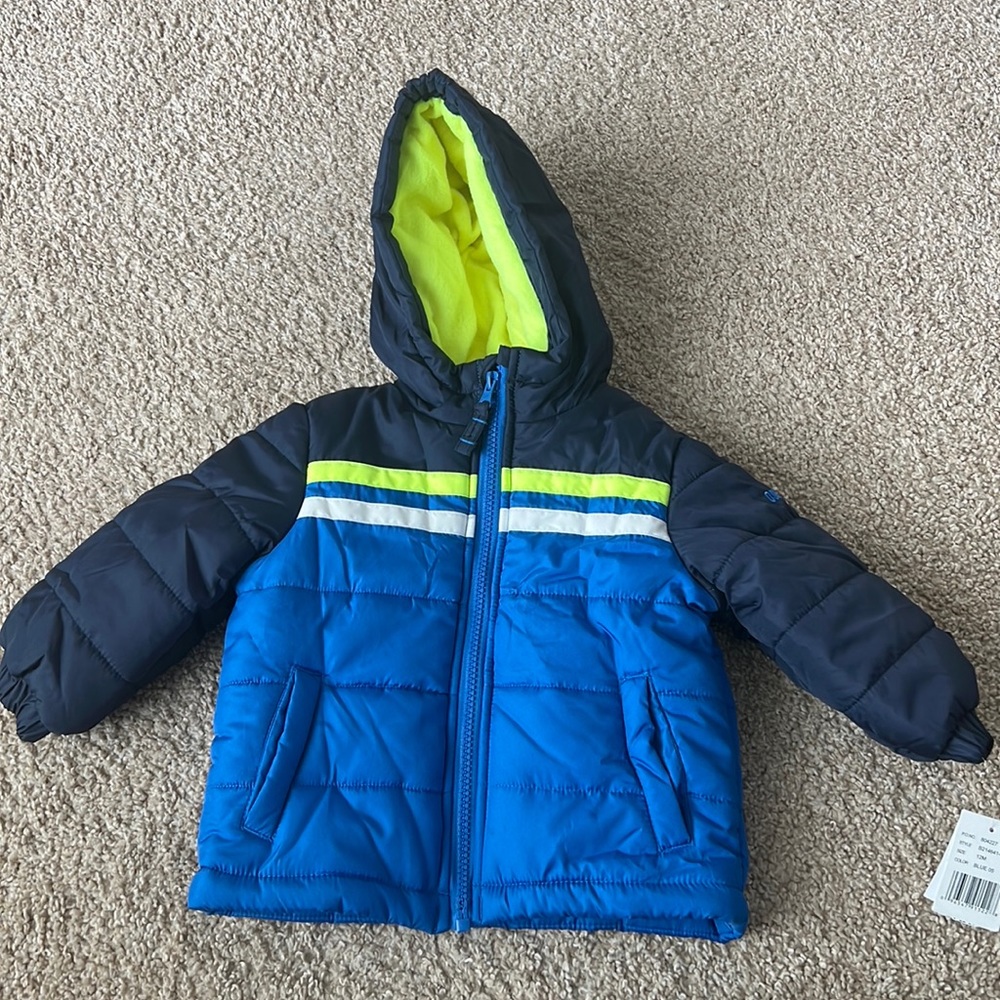 A 12 month baby winter jacket. Brand oshkosh. Never worn, tag still on.
